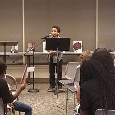 Young boy smiling at audience